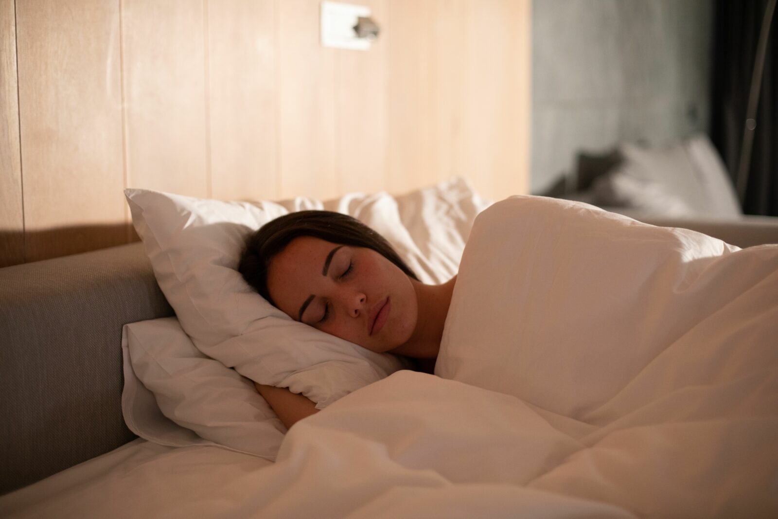 a woman sleeping in a bed